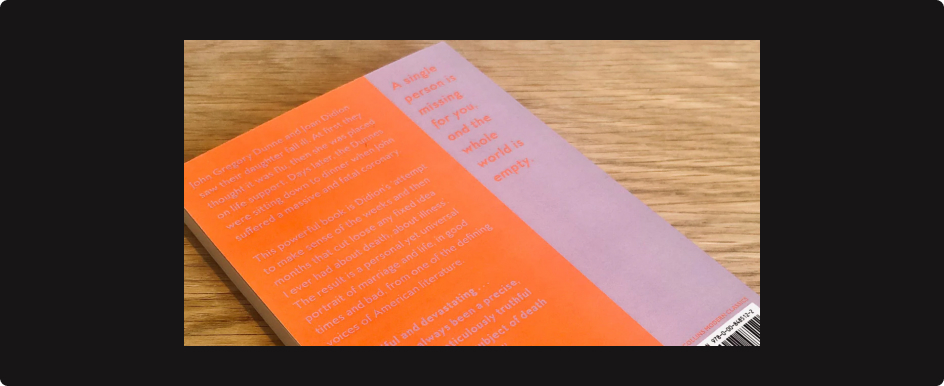 A photograph of the back cover of a book. The cover has an orange section
with purple text and a purple section with a quote in orange. The text is
barely legible due to the low colour contrast between the orange and
purple.